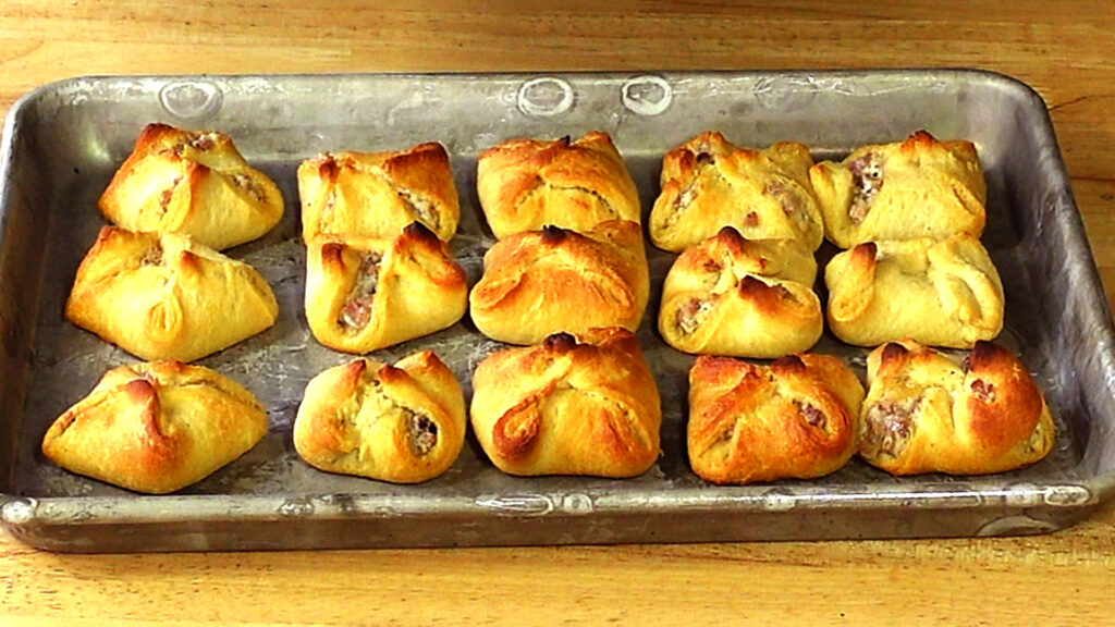 Crescent Roll Bites - Crescent Roll Dough cut into small squares and filled with a Sausage and Cream Cheese Filling